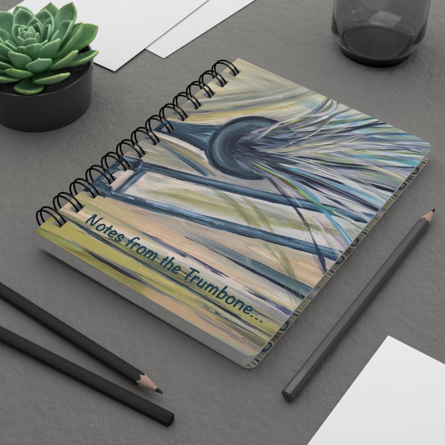 Notes from the Trumbone! Write down your dreams in style in our spiral-bound journal featuring "Trumbone Joyeux". Our notebooks feature a durable thick gloss laminated protective cover, with pattern repeat created from the original artwork on the inside front and back covers. Made in the USA! Journal comes in 5x7 size with 150 pages of lined paper with preforated eadge for easy tear removal! .: Front, back and inside cover print .: 150 lined pages (75 sheets) .: Glossy laminated cover