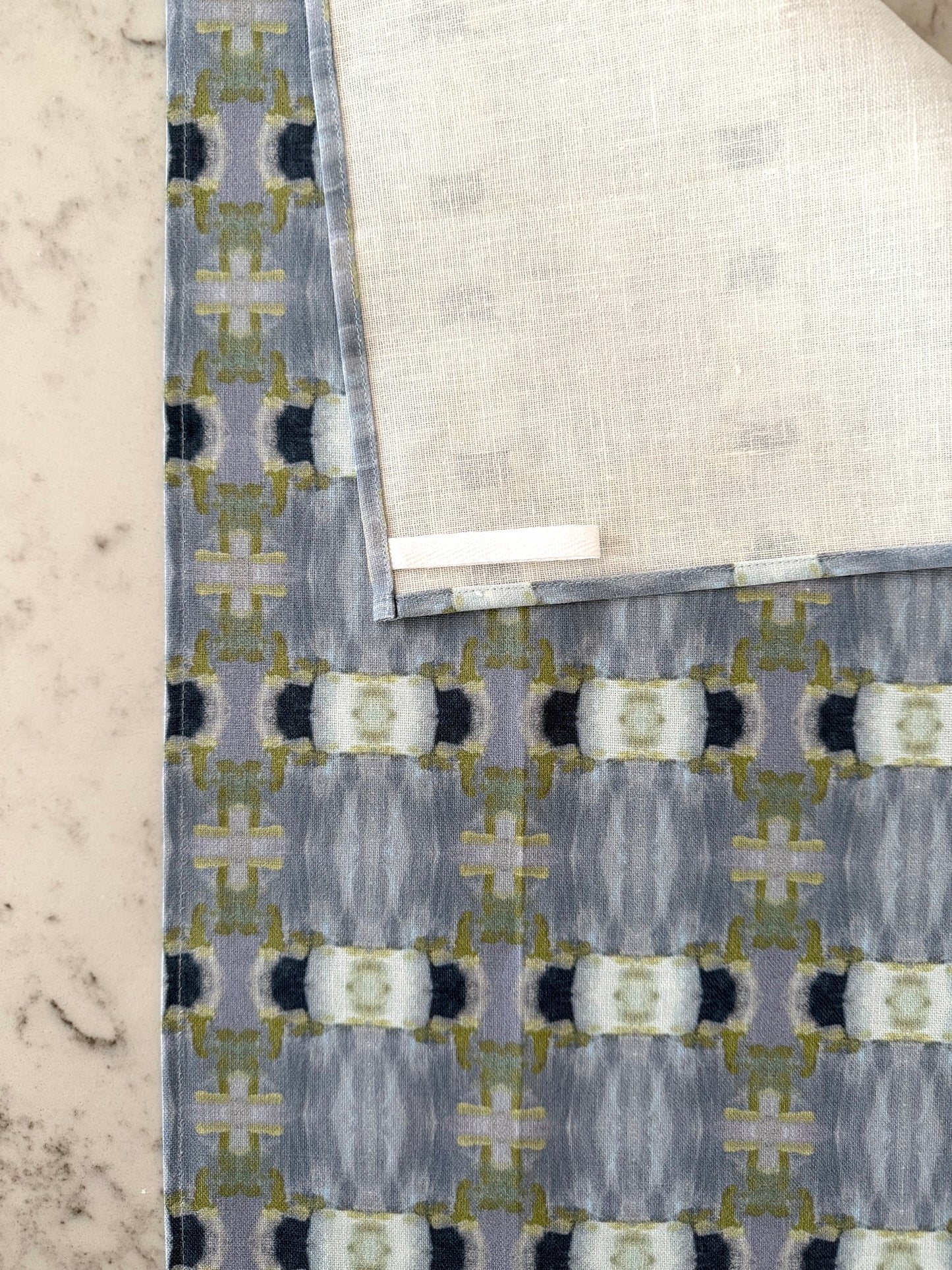 Crafted from 100% French linen woven from premium Normandy flax, each tea towel is printed and sewn in the USA and designed to bring lasting beauty into the kitchen and bath. Measuring 16x24 inches, the fabric offers the ideal balance of structure and softness - becoming more supple with every wash while maintaining its integrity.
Each pattern begins as an original fine art painting, translated into a layered geometric composition that preserves the movement, texture, and tonal depth of the artwork. The