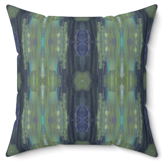 A square-shaped throw pillow with a geometric pattern featuring shades of green and blue.