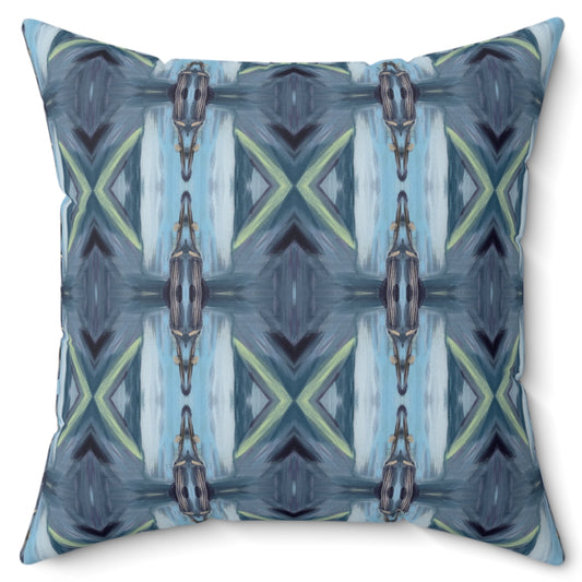 A square decorative pillow with a geometric pattern featuring shades of blue and green, and a chain-like design, on a white background.