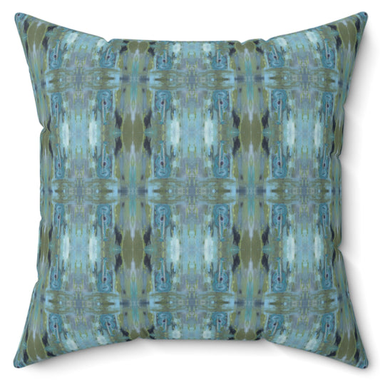 A square-shaped throw pillow with a geometric pattern featuring shades of blue and green, resembling a guitar design.