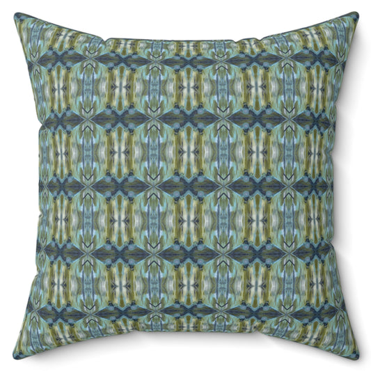 A square-shaped throw pillow with a geometric pattern featuring shades of blue and green.