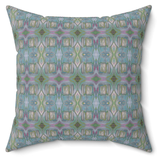 A square-shaped throw pillow with a geometric pattern featuring shades of blue and green.