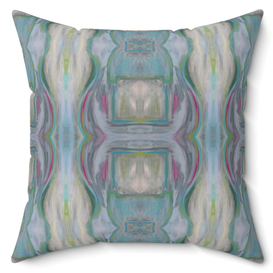 A square-shaped throw pillow with a multicolored geometric pattern featuring shades of blue and green.