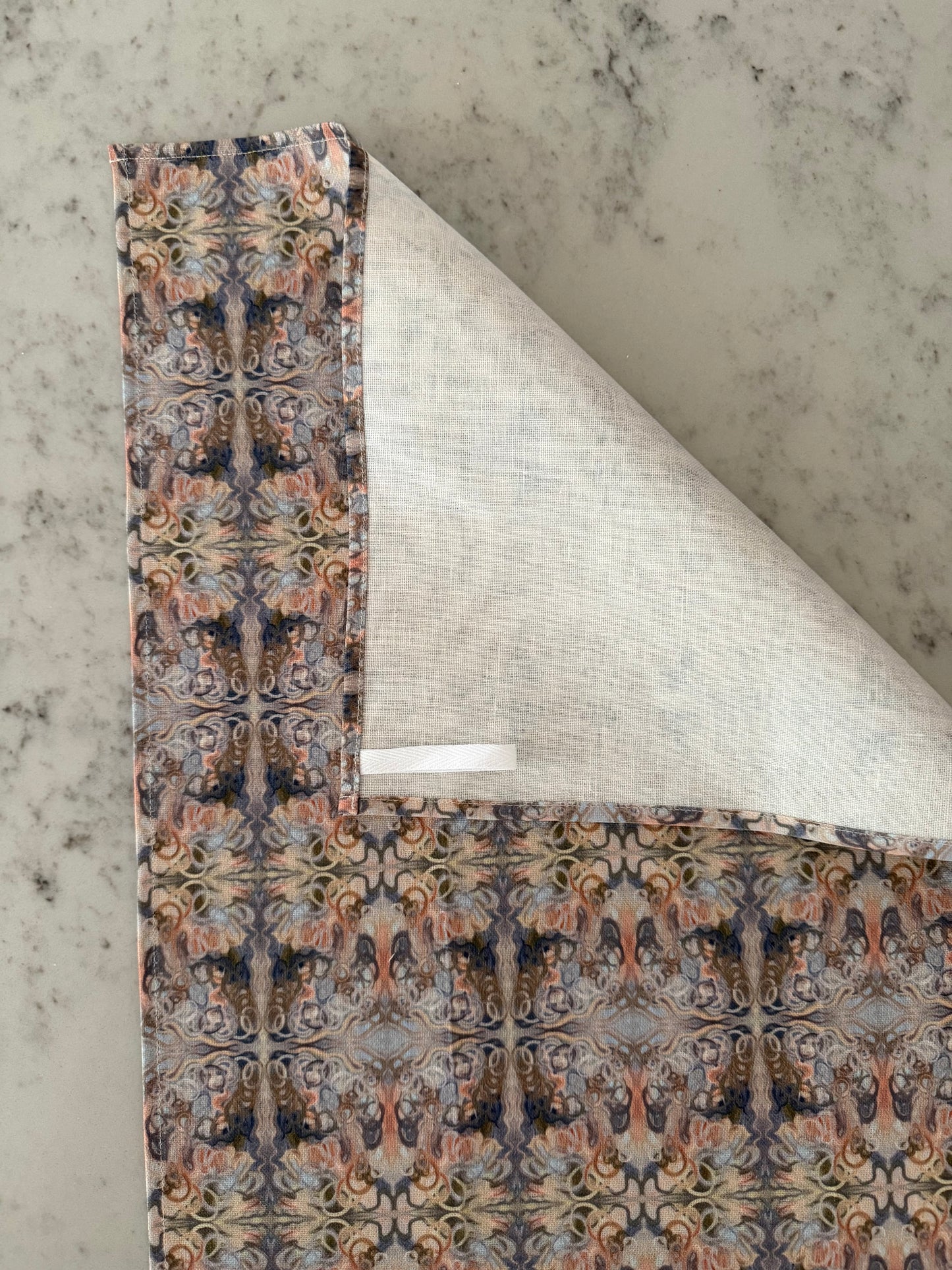 Crafted from 100% French linen woven from premium Normandy flax, each tea towel is printed and sewn in the USA and designed to bring lasting beauty into the kitchen and bath. Measuring 16x24 inches, the fabric offers the ideal balance of structure and softness - becoming more supple with every wash while maintaining its integrity.
Each pattern begins as an original fine art painting, translated into a layered geometric composition that preserves the movement, texture, and tonal depth of the artwork. The
