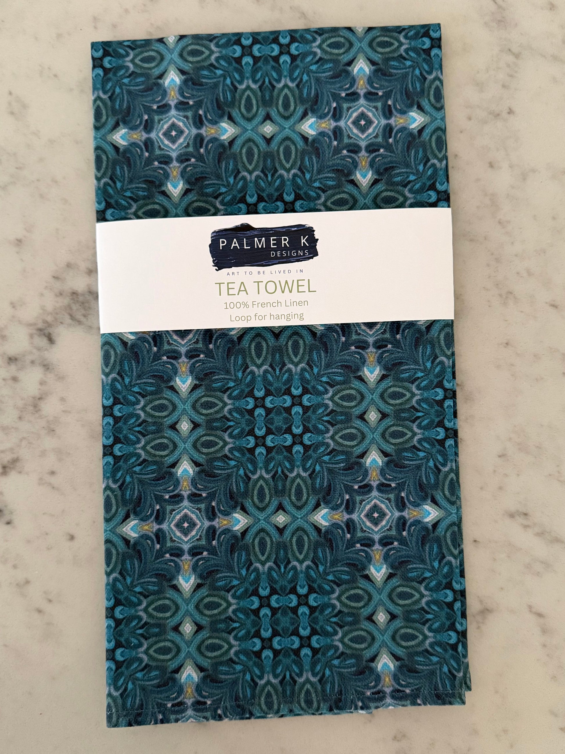 Crafted from 100% French linen woven from premium Normandy flax, each tea towel is printed and sewn in the USA and designed to bring lasting beauty into the kitchen and bath.  Measuring 16x24 inches, the fabric offers the ideal balance of structure and softness - becoming more supple with every wash while maintaining its integrity.

Each pattern begins as an original fine art painting, translated into a layered geometric composition that preserves the movement, texture, and tonal depth of the artwork.  The 