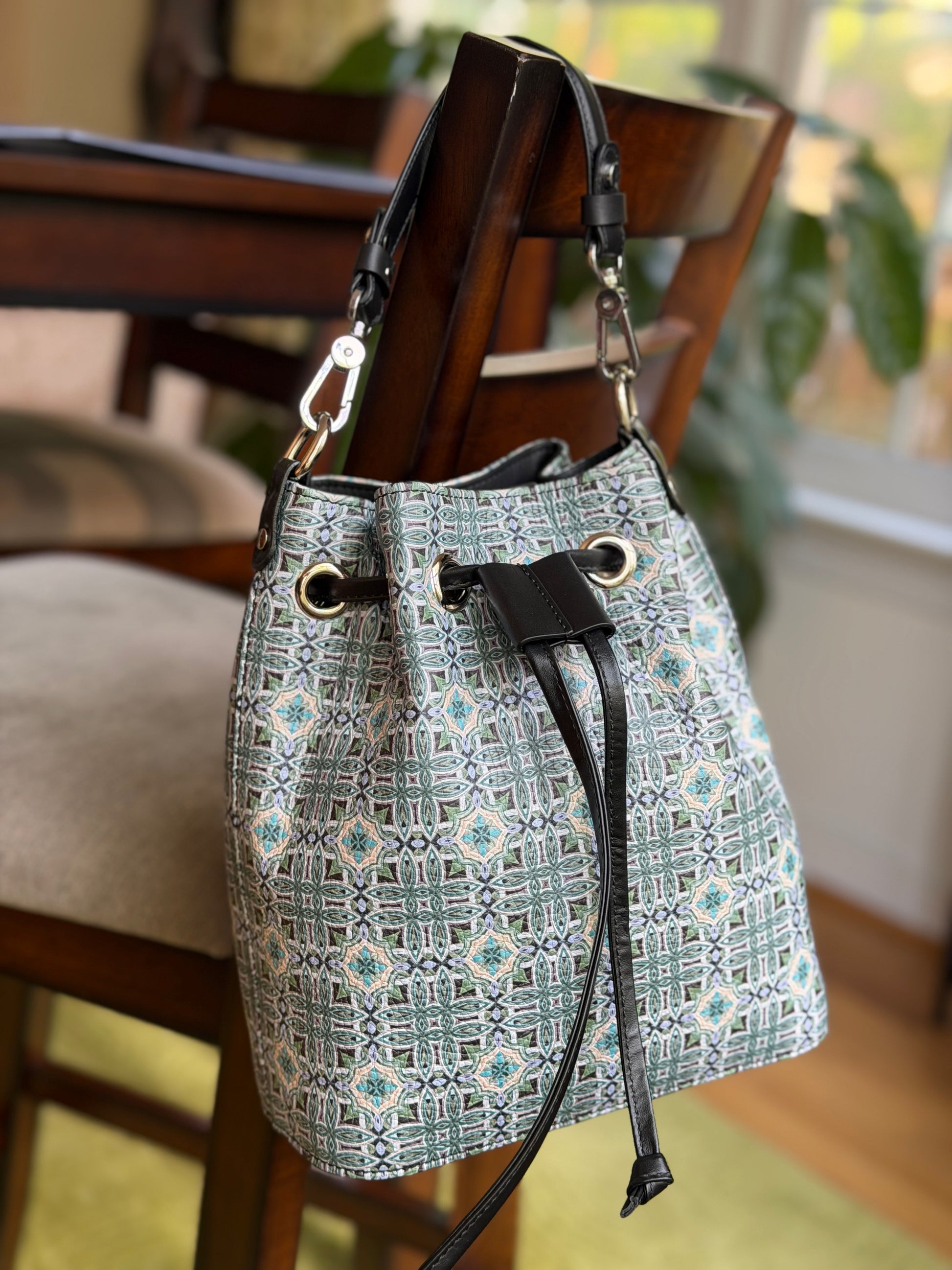 Front view of Maison Bucket Bag showcasing structured silhouette and fine art derived textile pattern, elegant luxury handbag for everyday use.