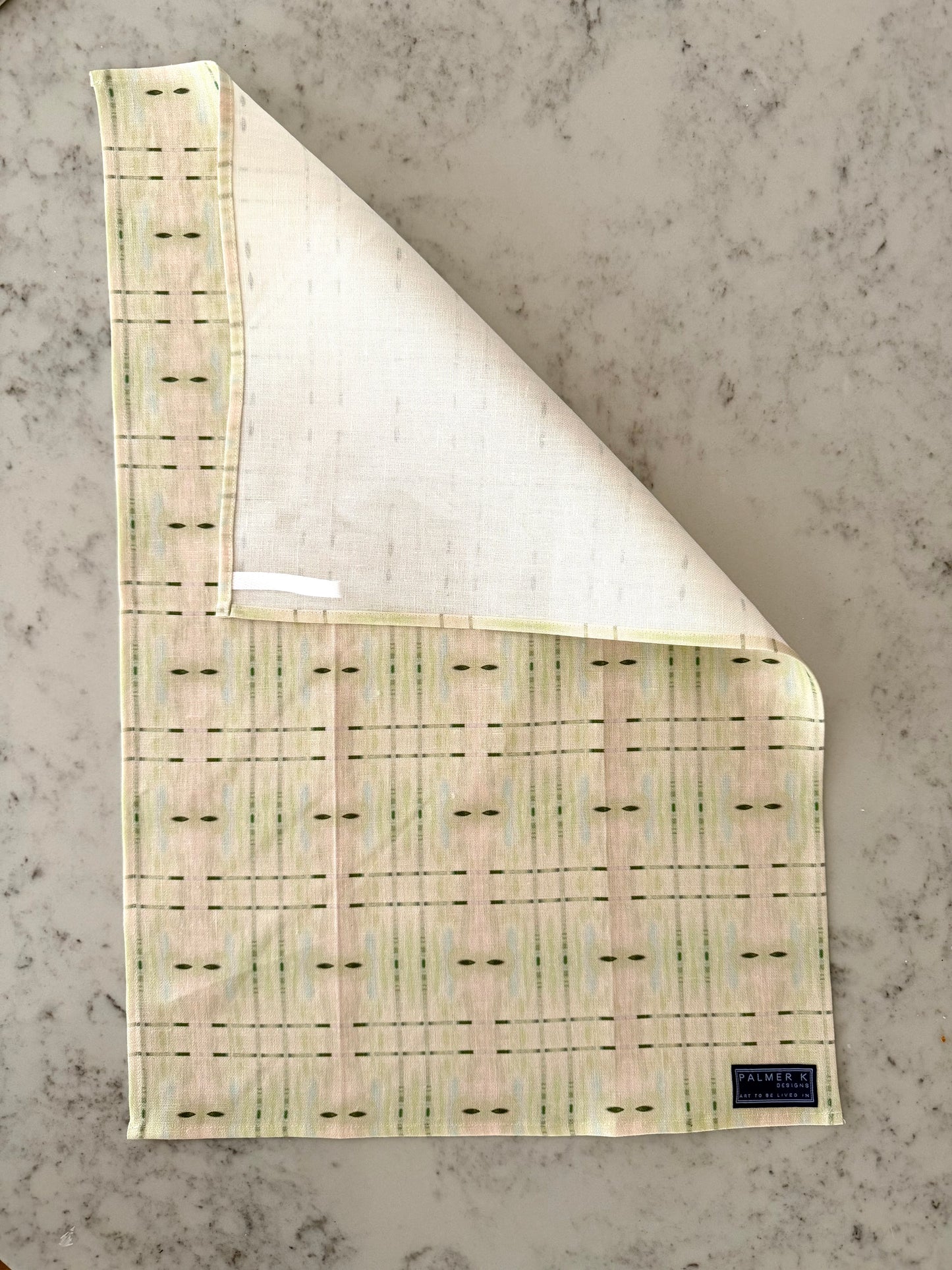 Crafted from 100% French linen woven from premium Normandy flax, each tea towel is printed and sewn in the USA and designed to bring lasting beauty into the kitchen and bath.  Measuring 16x24 inches, the fabric offers the ideal balance of structure and softness - becoming more supple with every wash while maintaining its integrity.

Each pattern begins as an original fine art painting, translated into a layered geometric composition that preserves the movement, texture, and tonal depth of the artwork.  The 