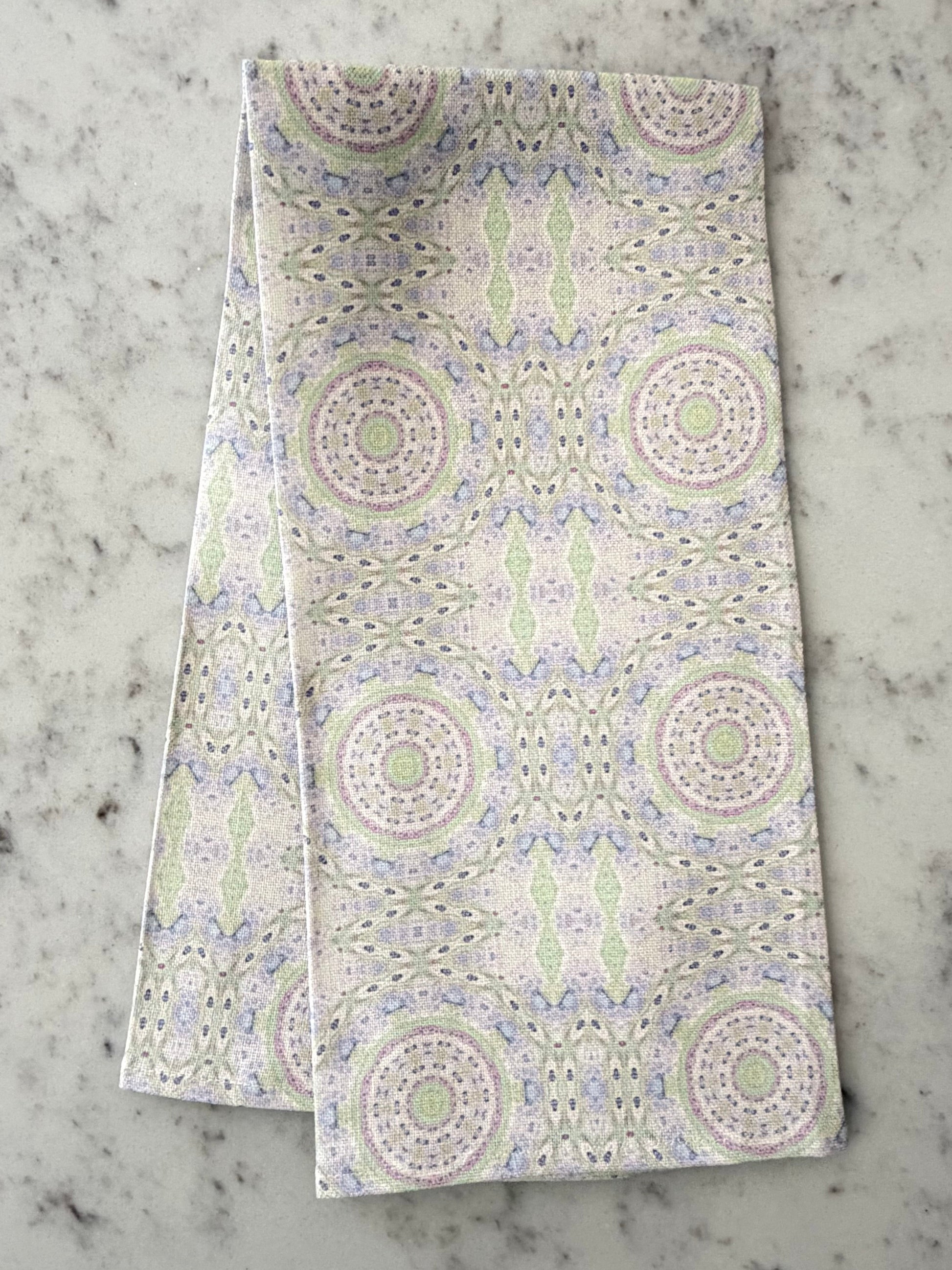 Crafted from 100% French linen woven from premium Normandy flax, each tea towel is printed and sewn in the USA and designed to bring lasting beauty into the kitchen and bath.  Measuring 16x24 inches, the fabric offers the ideal balance of structure and softness - becoming more supple with every wash while maintaining its integrity.

Each pattern begins as an original fine art painting, translated into a layered geometric composition that preserves the movement, texture, and tonal depth of the artwork.  The 