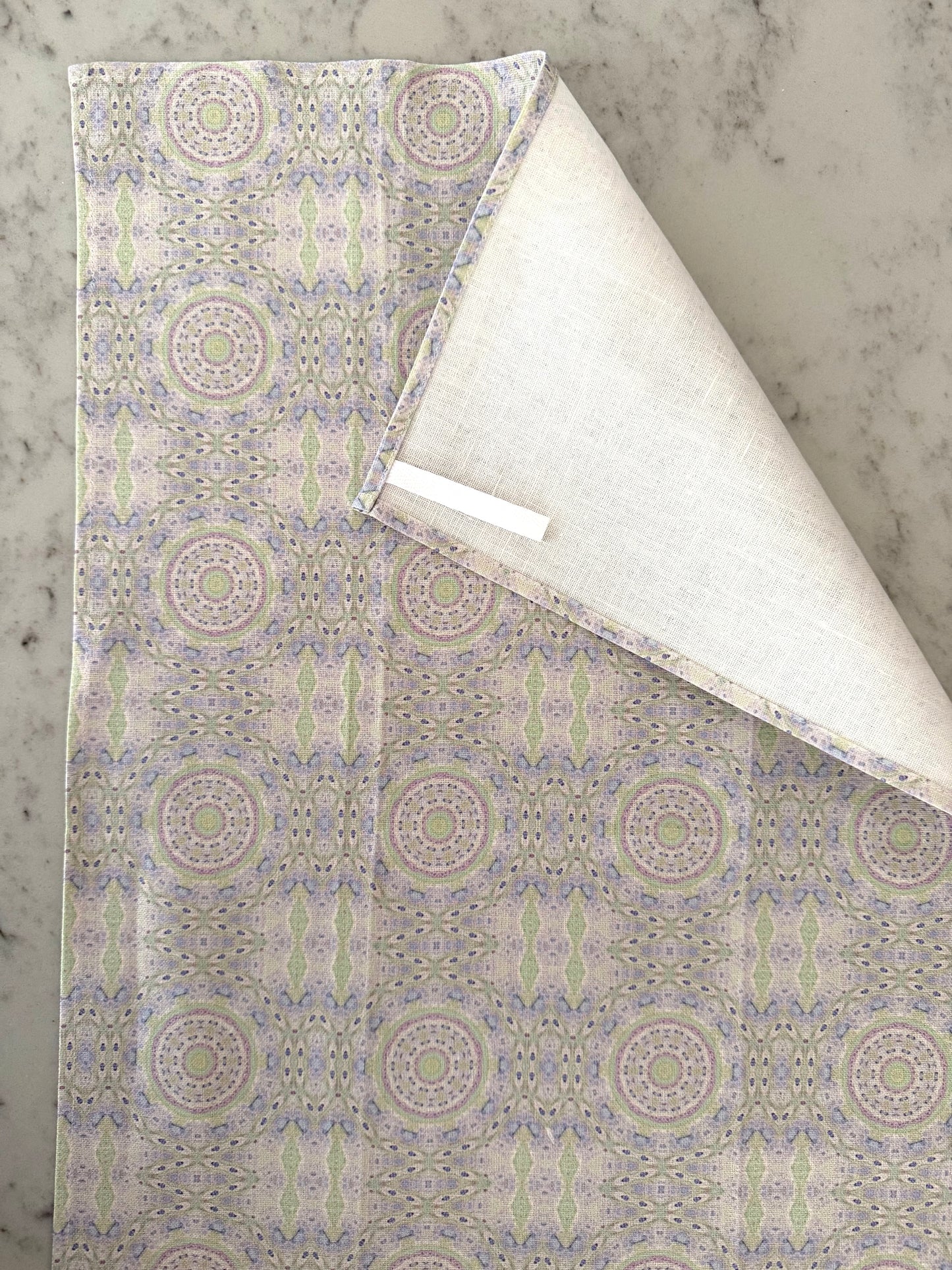 Crafted from 100% French linen woven from premium Normandy flax, each tea towel is printed and sewn in the USA and designed to bring lasting beauty into the kitchen and bath.  Measuring 16x24 inches, the fabric offers the ideal balance of structure and softness - becoming more supple with every wash while maintaining its integrity.

Each pattern begins as an original fine art painting, translated into a layered geometric composition that preserves the movement, texture, and tonal depth of the artwork.  The 